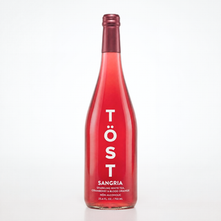 Red bottle of Töst Sangria on a white background
