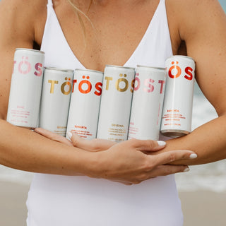 TOST cans in womans hand
