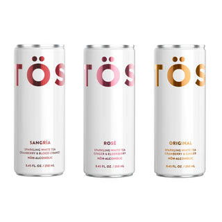 Three cans of TÖST sparkling white tea on a white background
